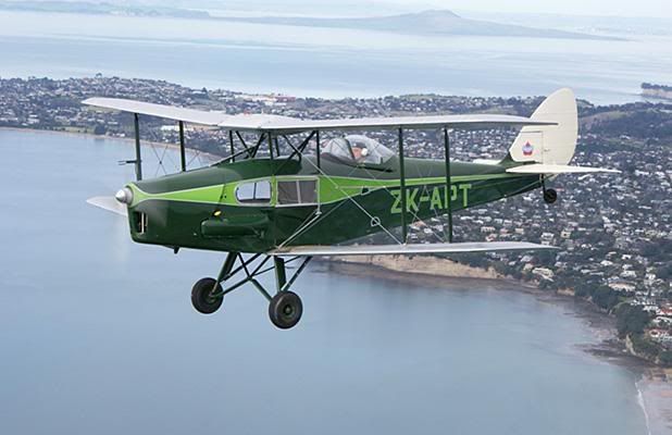 UP AND AWAY: Stan Smith, pictured over the Whangaparaoa Peninsula, is flying his de Havilland Fox Moth as part of celebrations for the 75th anniversary of New Zealand’s first airline. — Photo: JOHN KING.