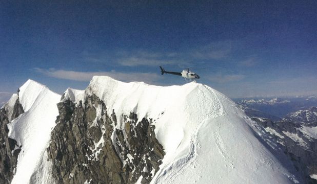 PEAK OFFENCE: A helicopter piloted by Jason Manderson hovering over the summit of Aoraki/Mount Cook on December 24, 2011.