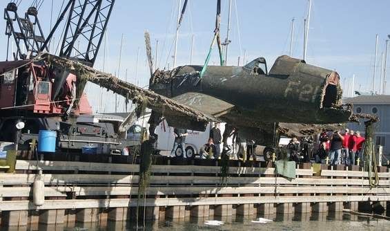 A World War II F4U-1 Corsair fighter plane was recovered from Lake Michigan Monday by A&T Recovery at Larsen Marine at Waukegan Harbor. The Corsair, piloted by Ensign Carl Harold Johnson, crashed into the lake during training exercises in 1943. — Gilbert R. Boucher II/Staff Photographer.