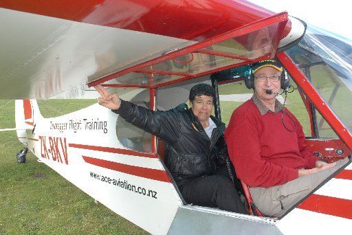 HISTORY MAKER: Kerry Conner, left, and John Bushell in the Piper Cub BKV, the first aeroplane to fly under the Auckland Harbour Bridge. — Photo: JAMES HOLLINGS.