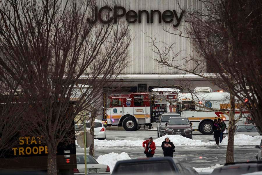 Civilians walk from a building after a shooting at a shopping mall in Columbia, Maryland on January 25th, 2014. Three people died in a shooting at a large shopping mall outside of Baltimore, Maryland, on Saturday, and one of the dead was believed to be the shooter, police said. — Photo:  James Lawler Duggan/Reuters.