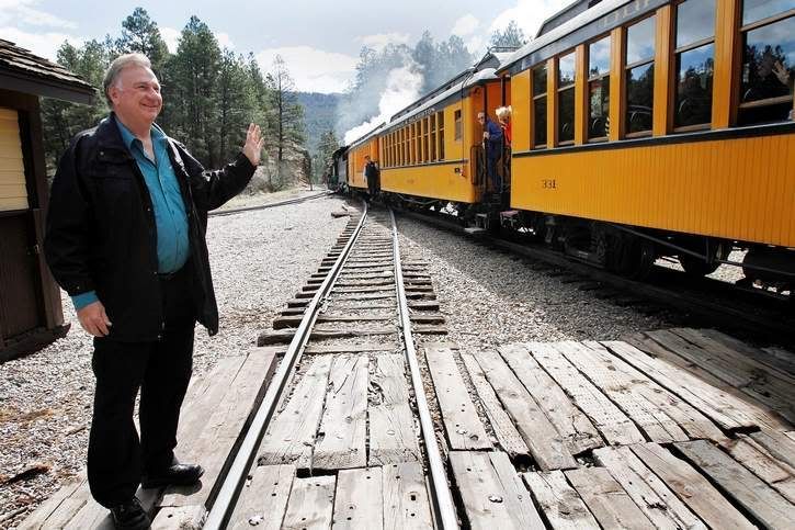 Al Harper, owner of the Durango & Silverton Narrow Gauge Railroad, waves to riders of the train during a brief pause at the Rockwood Station on the train's morning run to Silverton.  Photo: SHAUN STANLEY/The Durango Herald.