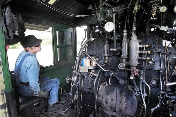 Isaac Randolph closely listens to and watches the engine gauges on the Durango & Silverton Narrow Gauge to get a feel of how the engine is running.