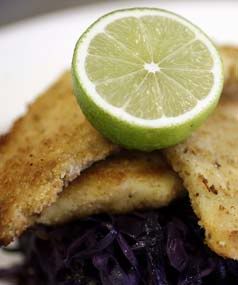 COLOURFUL COOKING: Golden crumbed fish lies on a bed of red cabbage, ginger and a green apple, all topped off with a lime.  CAMERON BURNELL/Taranaki Daily News.