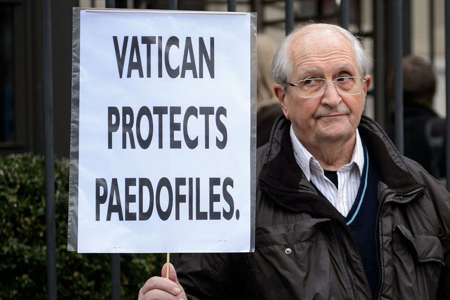 A man holds a placard during a demonstration against the Holy See outside the headquarters of the United Nations High Commissioner for Human Rights in Geneva on January 16th, 2014. Vatican envoys are to face questions over clerical abuse of children at a hearing of a UN children's rights committee.  Photo: Fabrice Coffrini/AFP/Getty Images.