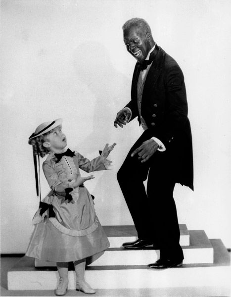 Shirley Temple and tap dancer Bill “Bojangles” Robinson are shown in a scene from the 1935 motion picture “The Little Colonel”, one of four movies they appeared in together. — Photo: Associated Press.