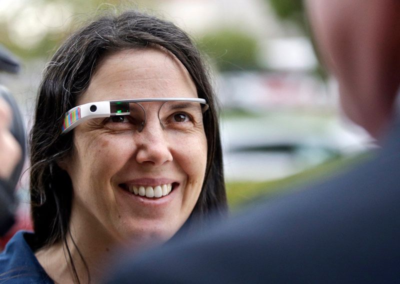 Cecilia Abadie wears her Google Glass as she talks with her attorney outside of traffic court. The traffic commissioner dismissed a ticket issued her for wearing the glass while driving.  Photo: Lenny Ignelzi/Associated Press.