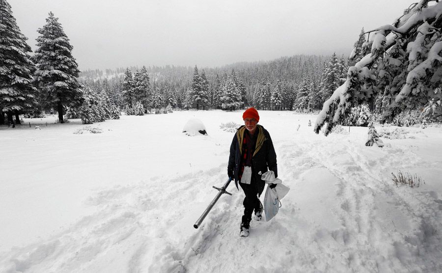Frank Gehrke, chief of the California Cooperative Snow Survey Program for the Department of Water Resources, leaves a snow-covered meadow after the second snow survey of the year near Echo Summit, California. Gehrke said that while recent snow fall will help bolster the depleted snowpack, it is not enough to affect the water supply. — Photo: Associated Press.