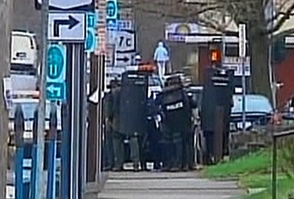 Police carrying shields respond to Binghamton, N.Y., shooting. (WBNG via CNN)