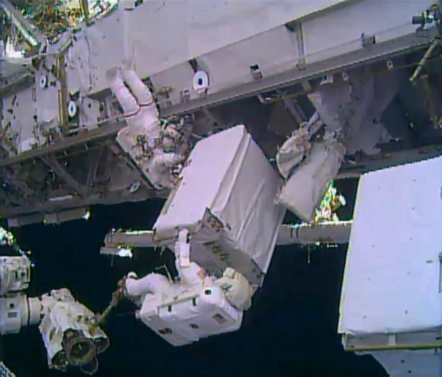 A NASA TV image shows astronauts Mike Hopkins, left, and Rick Mastracchio position a spare ammonia pump during a spacewalk outside the International Space Station.  Picture: AFP/Getty Images/December 24th, 2013.