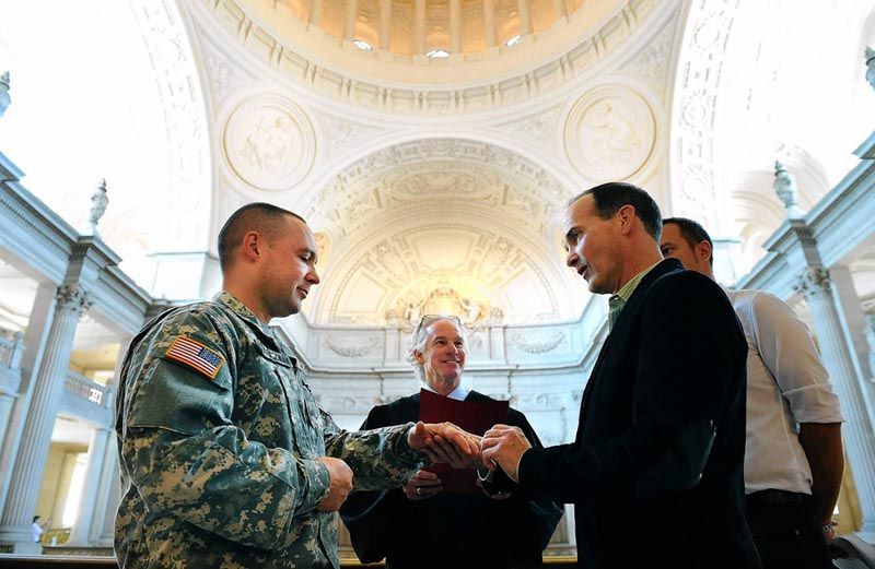 Army Sergeant Michael Potoczniak, left, and his partner, Todd Saunders, exchange rings during their marriage ceremony at San Francisco City Hall on Saturday.  Photo: Wally Skalij/Los Angeles Times.