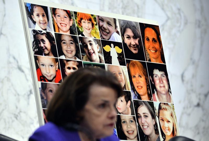 Pictures of Sandy Hook Elementary School shooting victims are displayed behind assault weapons ban advocate Senator Dianne Feinstein. — Photo: Jewel Samad/AFP/Getty Images/February 27, 2013.