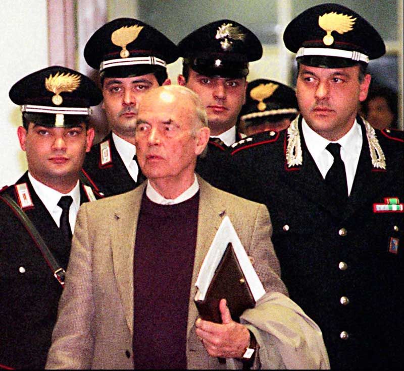 Former Nazi SS officer Erich Priebke enters the military court in Rome on December 7th, 1995. Priebke was eventually convicted in the massacre of 335 civilians in 1944. He died October 11th at 100. — Photo: Domenico Stinellis/Associated Press.