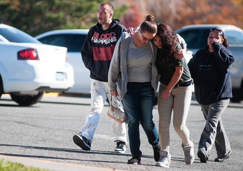 A Sparks Middle School student and her mother walk together after students were evacuated following a shooting that left two dead at the school. — Photo: Kevin Clifford/Associated Press/October 21st, 2013.
