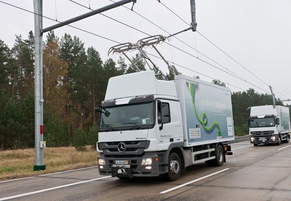 Trucks travel along a test track in Germany, where Siemens is working on its eHighway concept, which runs diesel hybrid trucks on overhead electric wires. This system has been proposed to cut pollution on Interstate 710 in L.A.  Photo: Siemens Corporation.