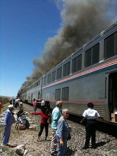 Passengers and crew exit the Amtrak train. — Ron Almgren/Associated Press/June 24, 2011.