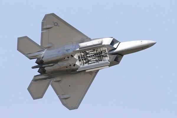 An F-22 Raptor's weapon bays are visible during a demonstration at Langley Air Force Base in Hampton, Virginia, in April.  Photo: Steve Helber/Associated Press/April 30, 2012.