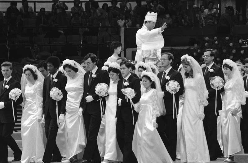 Couples march in a mass wedding procession in New York's Madison Square Garden as the Rev. Sun Myung Moon presides over the ceremony, which included more than 2,000 couples. Moon served as matchmaker for the couples. About a third included men and women of difference races or nationalities, in keeping with the church's belief that interracial marriage can help end racism.  Photo: Marty Lederhandler/Associated Press/July 02, 1982.