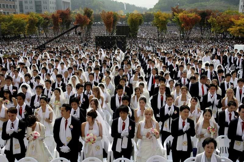 Couples from around the world participate in a mass wedding ceremony at Sun Moon University in Asan, South Korea, arranged by the reverend's Unification Church.  Photo: Lee Jin-man/Associated Press/October 14, 2009.