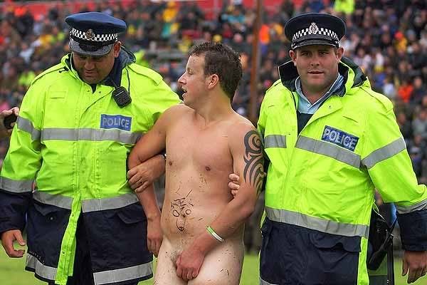 POLICE ESCORT: A streaker is led away by police after being followed an exhibition during the Blues v Hurricanes pre-season Super 14 game.