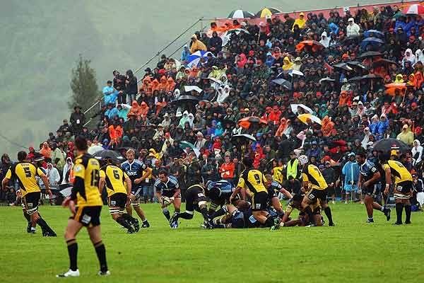 WET ONE: Raincoats were the order of the day as spectators watch Blues halfback Alby Mathewson run from the base of a ruck during the Blues v Hurricanes pre-season Super 14 rugby match in Mangatainoka.