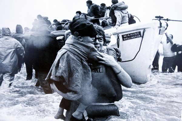 THE LUCKY ONES: Wahine survivor Sue Willoughby carries Ian Johnson, 5, to shore. More than 700 people had to abandon ship, and 51 of them died.
