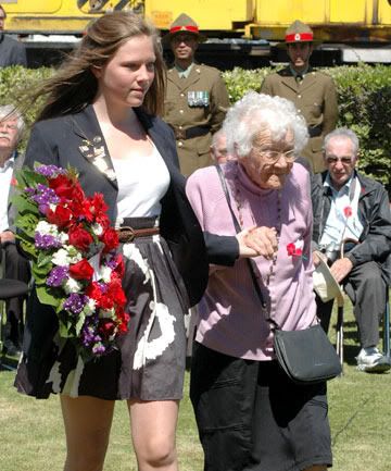 ACROSS THE OCEANS: Belgian Rotary exchange student Manoelle Godin, 18, escorts 95-year-old Eileen Smeaton to lay a wreath to commemorate railwaymen killed in the Battle of Passchendaele. The memorial was unveiled on Armistice Day at KiwiRail's Hutt Workshops. — NICHOLAS BOYACK/Hutt News.