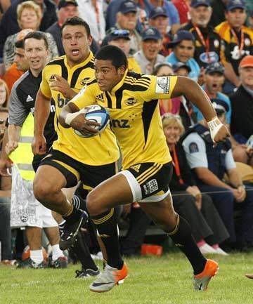 GO YOU GOOD THING: Hurricanes wing Julian Savea races up the sideline with Jacob Ellison in support as the crowd at Mangatainoka gets a closeup view of the Super 15 warmup match on Saturday. — PHIL REID/The Dominion Post.