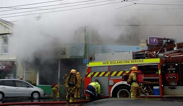 TAKEAWAYS: Fire crews battle a fire at a fish and chip shop in Haitaitai.  Photo: KAT FORBES.