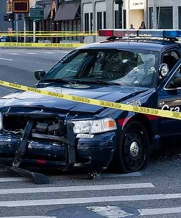 BULLET HOLES: A Grand Rapids police car that was both hit and fired upon sits abandoned in Grand Rapids after suspect Roderick Dantzler led police on a high speed chase.  Photo: Associated Press.