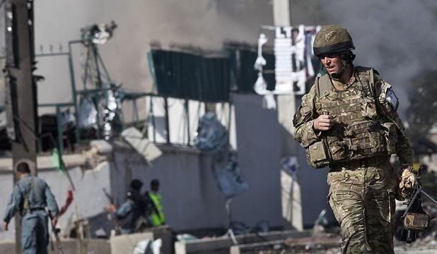 GUN BATTLE IN KABUL: A British soldier walks in front of the site of attack on offices belonging to the British Council in Kabul.  Photo: Reuters.