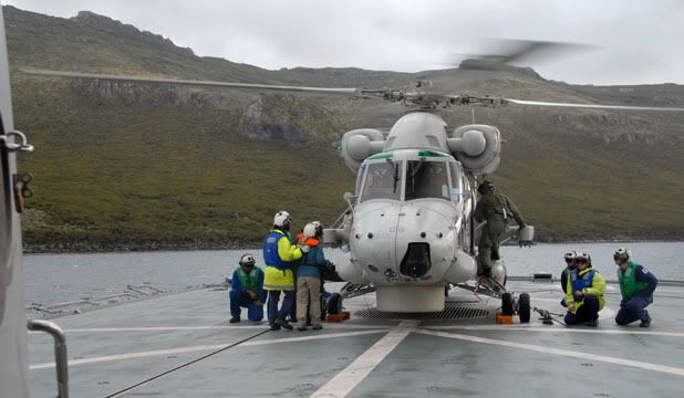 SPARES HEADACHE: A navy Seasprite helicopter is prepared for flight aboard HMNZS Te Kaha in Perseverance Harbour, Campbell Island.  Photo: MICHAEL FIELD/Fairfax Media.