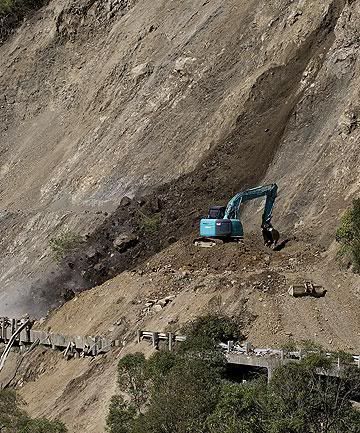 STILL SHUT: Work continued last week on clearing the gorge road after it was closed by a big slip. — MURRAY WILSON/Manawatu Standard.