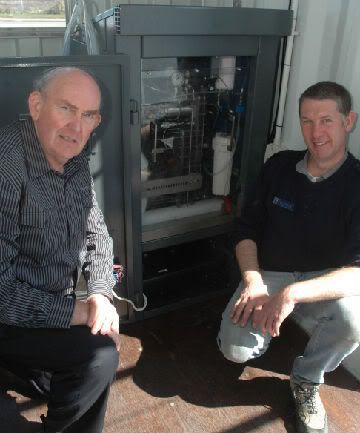WORLD FIRST: Malcolm Sime, left, and Tony Pearson are alongside IRL's Hylink unit, developed to respond to the variable generation of a wind turbine to make hydrogen.  SIMON EDWARDS/Hutt News.