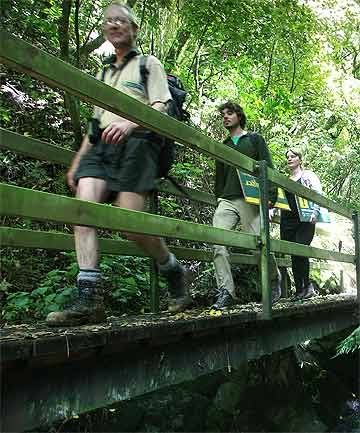STILL OPEN: Department of Conservation ranger Tim Groenendijk with DOC volunteers Alex Glass and Debby Brunskill on the Manawatu Gorge walk. — Photo: MURRAY WILSON.