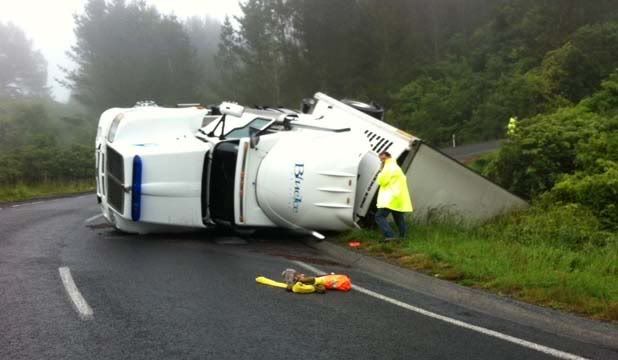 CRASHED: A truck's trailer unit over the edge of the road on the Pahiatua Track. — Photo: KEN CARRINGTON.