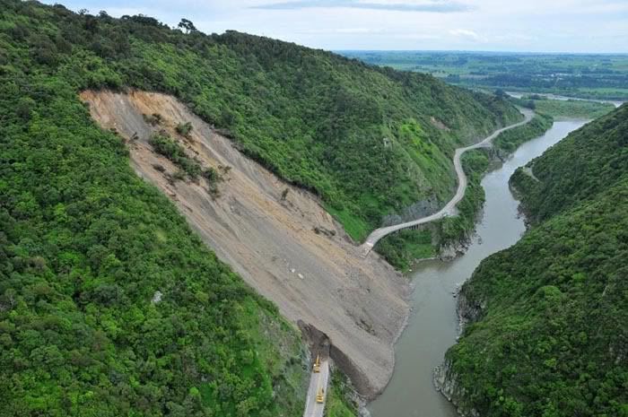 LANDSLIDE: Workers using heavy machinery attempt to clear the Manawatu Gorge. The road was blocked when 20,000 cubic metres of rubble was brought down by rain last month. — Photo: NZTA.