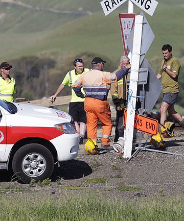 AT THE SCENE: Emergency services and KiwiRail workers at a rail crossing north of Woodville where a light truck was hit by a freight train.  ROBERT KITCHIN/Fairfax NZ.