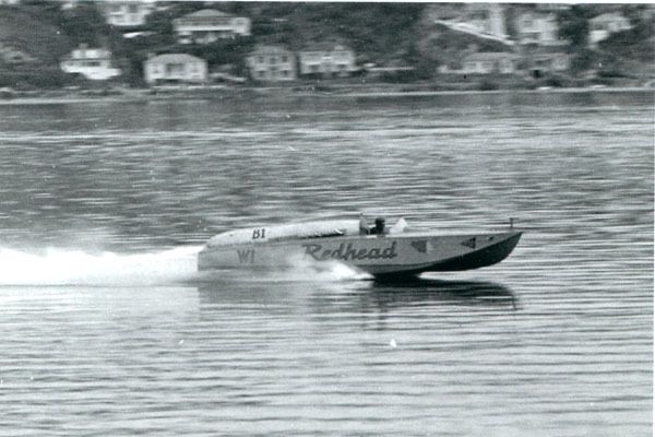 DOING THE TON: Redhead breaks the 100mph barrier on Evans Bay, February 22nd, 1953.  Photo: ALEXANDER TURNBULL LIBRARY.
