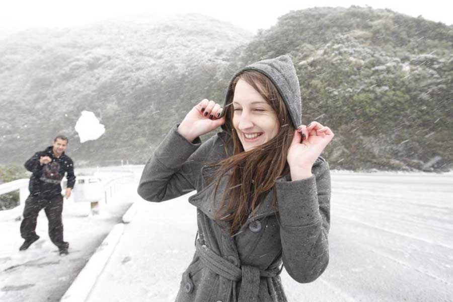 SNOWBALL FIGHT TIME: Several drivers were momentarily stranded at the Summit due to snow. — KENT BLECHYNDEN/Fairfax NZ.