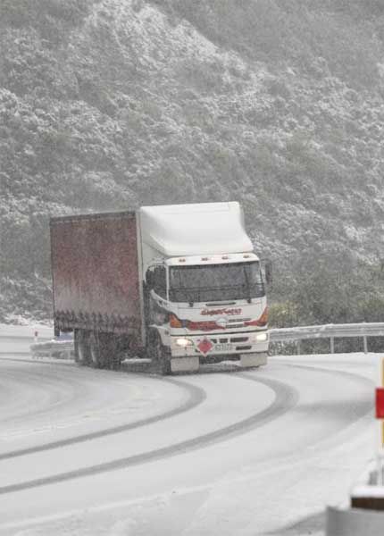 FIRST GEAR: A truck climbs slowly to the snowy summit of Rimutaka Hill. — KENT BLECHYNDEN/Fairfax NZ.