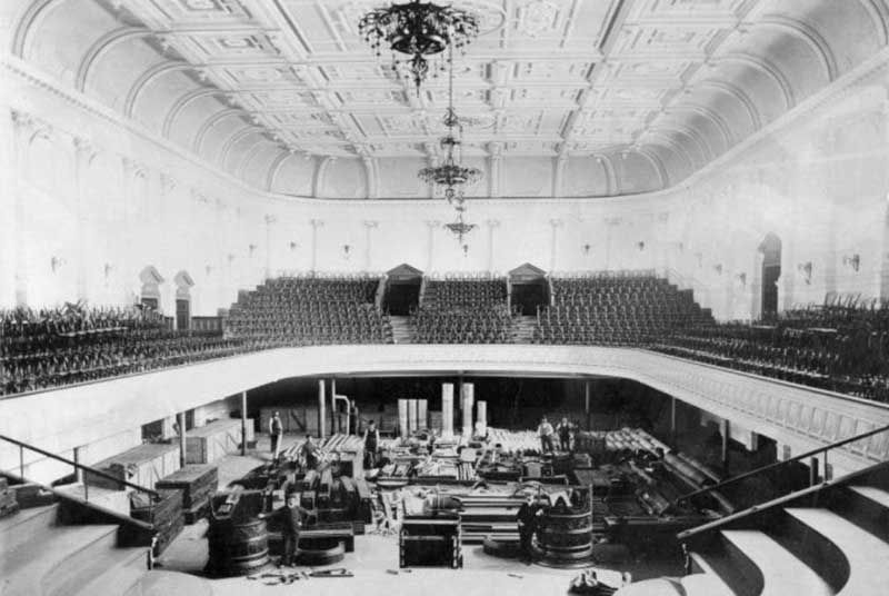 Inside the main auditorium in the Town Hall's early days with the organ being unpacked prior to being errected.