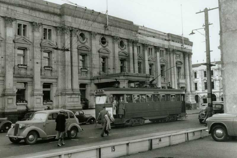 A tram, that icon of early to mid-20th century Wellington, rumbles by.