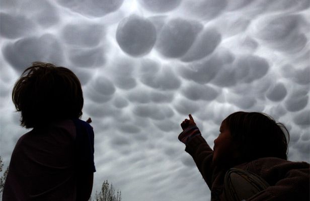 UNUSUAL SIGHT: Japhy and Enzo Fuller look at the strange clouds over Masterton.  PIERS FULLER/Fairfax NZ.
