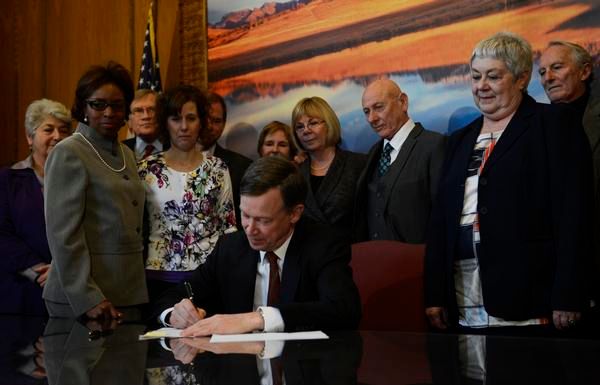 Colorado Governor John Hickenlooper, sign three gun bills in his office at the state capitol, March, 20, 2013. — Photo: R. J. Sangosti/The Denver Post.