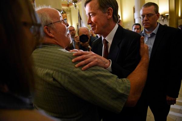 Tom Sullivan, left, whose son was killed in the Aurora theater shooting, hugs Governor John Hickenlooper after he signed three gun-control bills into law Wednesday. — Photo: R. J. Sangosti/The Denver Post.