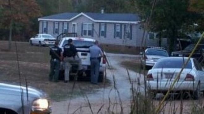 Sheriff's deputies gather outside a house where six people, including two children, died in a shooting in Greenwood, South Carolina. — Photo: FoxCarolina.