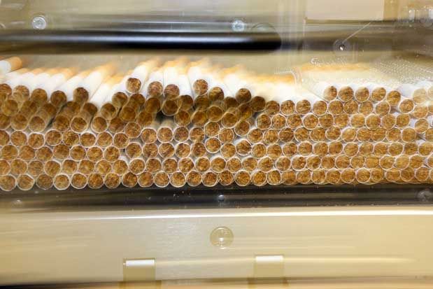 Freshly cut cigarettes make their way through a machine at Imperial Tobacco.  Photo: Hagen Hopkins.