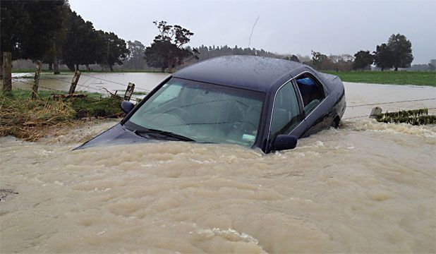 SUBMERGED: A car is submerged on Kokotau Road in Carterton district.  Photo: MARK ROUND.