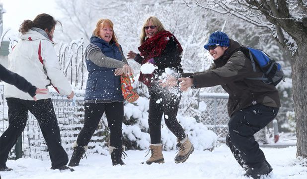 TAKE THAT: Lake Tekapo experienced snow overnight on Monday and, from left, Sally Kahl, Anne Petterson, Lynne Frost and James Cage decided to have some fun.  JOHN BISSET/Fairfax NZ.
